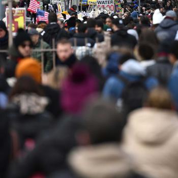People walk along the Brooklyn Bridge on the bridge's Manhattan side promenade entrance, on January 1, 2024. 