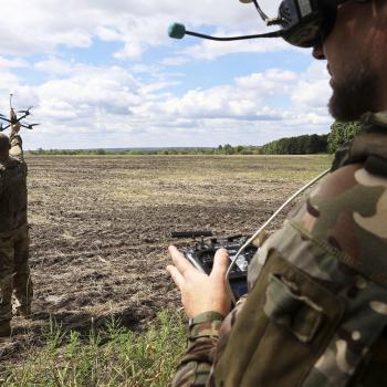 A Ukranian soldier holds a UAV as another soldier wears a headset during the training of drone pilots, Ukraine. Photo taken on August 12, 2025.