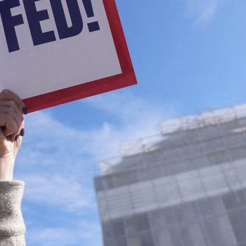 A protester against Trump’s tariffs holds a sign outside the US Supreme Court, as its justices are set to hear oral arguments on the President’s bid to preserve sweeping tariffs, in Washington, DC. Picture taken on November 5, 2025. 