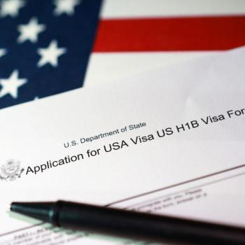 A US flag and H-1B Visa application form are seen in this photo illustration, taken on September 22, 2025. 