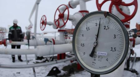 A worker inspects valves and pipes at an oil gathering station in Russia. 