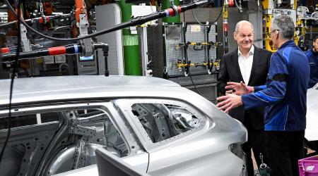 German Chancellor Olaf Scholz speaks with the Director of the BMW Group Plant Peter Weber during a visit at the factory, in Munich, Germany, December 5, 2023. 