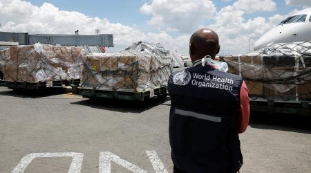 A world health organization (WHO) worker watches as a shipment of medical supplies to fight the coronavirus disease (COVID-19) arrives in Nairobi, Kenya. March 24, 2020. 