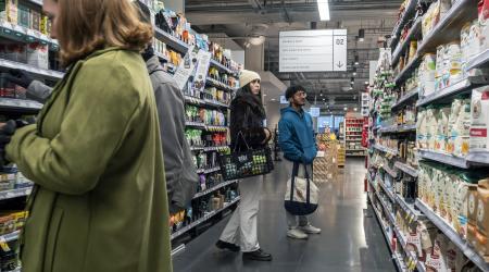 People contending with inflation at a food market in New York. 