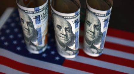 Photo illustration of US currency and the US flag. 