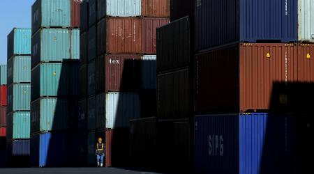 A worker walks in a container area at a port in Japan, on January 25, 2016.