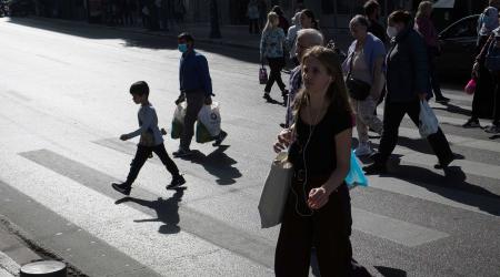 People cross on the pedestrian crossing in Athens, Greece on October 26, 2022. 