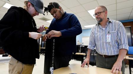 Instructor Joe Redemske watches Max Rivers, 19, left, and Isaiah Bryant, 18, work on a control multiple computer before installing it into a server rack during a computer information technology class at the Tennessee College of Applied Technology on Thursday, March, 28, 2024, in Portland, Tenn. Students are taking classes to improve their skills for jobs with in-demand industries. There are two job openings for every available skilled worker in Tennessee.