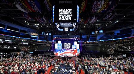 The slogan “Make America Wealthy Again” is displayed on the main monitors during the first day of the Republican National Convention. July 15, 2024, Milwaukee, WI.  
