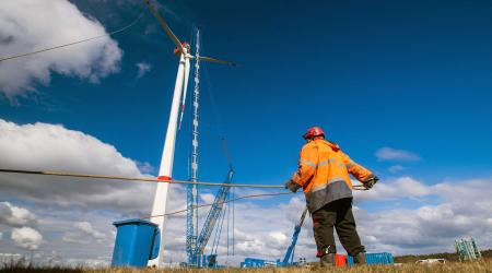 A special crane is used to lift the pre-assembled propeller to the nacelle of a wind turbine in Hoort, Germany. Picture taken March 31, 2020. 