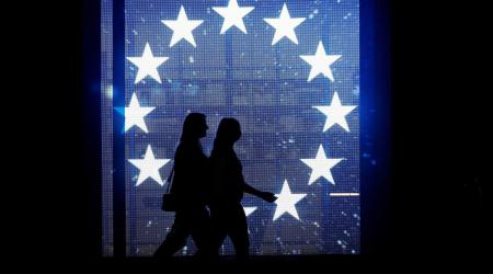 People walk past a projection of a flag of the European Union in Berlin, Germany. Picture taken on August 19, 2019. 