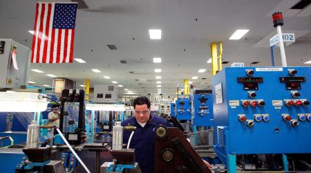 A worker monitors machines at a factory in Boston, Massachusetts. 