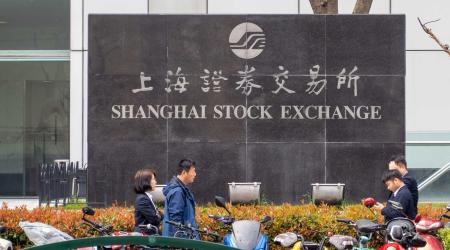 People walk past the Shanghai Stock Exchange in front of the Lujiazui Securities Building in Pudong, Shanghai, China. Picture taken on March 25, 2024. 