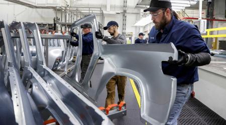 Employees work on an assembly line at a factory in Normal, Illinois, US April 11, 2022. 