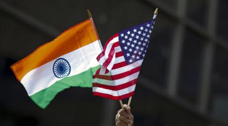 A man holds the flags of India and the US in New York City. 