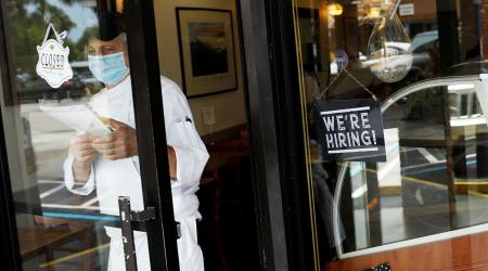 A "We're Hiring" sign is seen at the entrance of a restaurant in Miami, Florida, as some of the lockdown measures are lifted during the COVID-19 outbreak. May 18, 2020. 