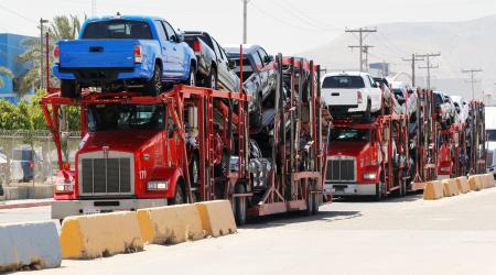 Carrier trailers que at the border waiting for customs control to cross into the US, at the Otay border crossing in Tijuana, Mexico. 