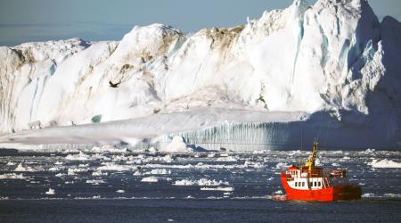 A boat passes icebergs in Disko Bay near Ilulissat, Greenland on September 16, 2021. 