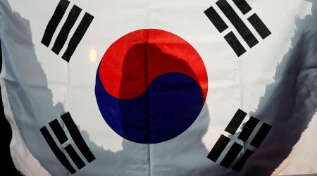 A person holds a South Korean flag in front of the National Assembly in Seoul, South Korea. Picture taken on December 6, 2024. 