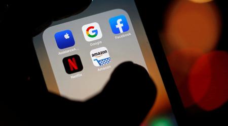 The logos of mobile apps are displayed on a cell phone screen in this photo illustration. 