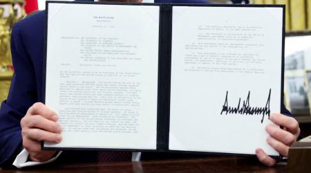 US President Donald Trump holds an executive order on reciprocal trade and tariffs in the Oval Office of the White House, Washington, DC. February 13, 2025. 