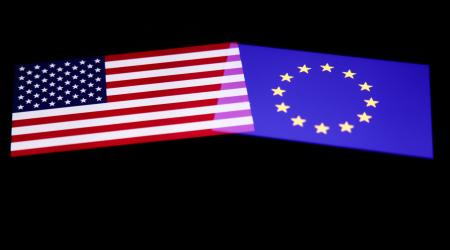 The flags of United States and European Union are displayed on a screen. 