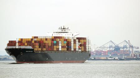 A cargo ship stacked with containers is underway in the New York Harbor in New York City. 