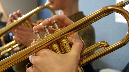 Students play the trumpet during lessons. 