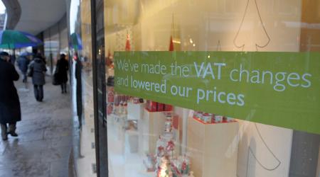 A value added tax (VAT) sign is seen in the window of a store in Europe. 