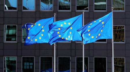 European Union flags flutter outside the European Commission headquarters in Brussels, Belgium.