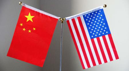 The national flags of China and the United States are displayed on a table in Ji'nan City, China. 