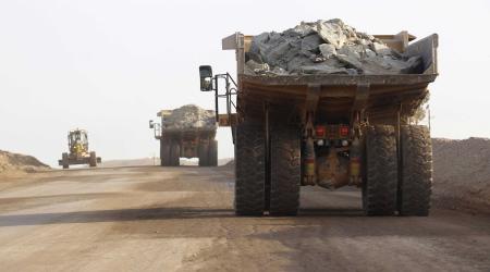 Trucks carry ore from a mining pit in east Africa. 