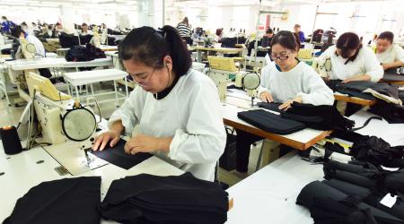 Workers produce garments for export at a workshop in Lianyungang, Jiangsu province, China. Photo taken on April 8, 2025. 
