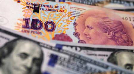 Argentine peso and US dollar bills are shown in this photo illustration. Picture taken October 17, 2022. 