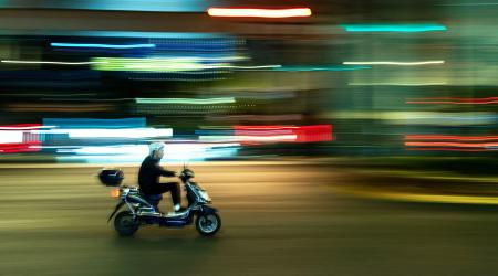 A man rides his scooter in the street in Shanghai, China. Picture taken on November 4, 2025. 