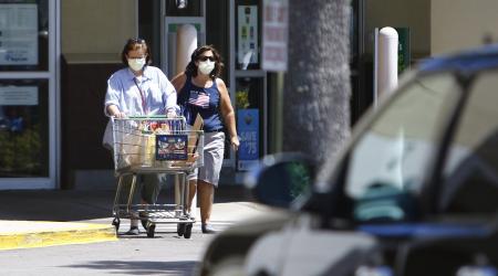 Patrons exit a supermarket in Florida where consumer prices have soared due to inflation. 