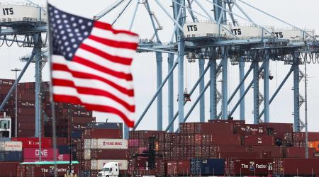 A US flag flutters in front of shipping containers at the Port of Long Beach in Long Beach, California. Photo taken on July 11, 2025. 