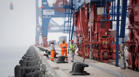 Workers stand on a platform at Peru’s Port of Chancay, built by China's state-owned Cosco Shipping to be a hub for shipping lithium and other critical minerals from South America to China. Picture taken on October 24, 2024. 