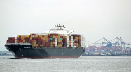 Containers are stacked on the deck of cargo ship in New York Harbor in New York City. 