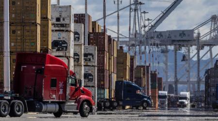 Shipping containers and trucks are seen at the port in Oakland, CA as trade tensions escalate over US tariffs. Picture taken on March 6, 2025. 