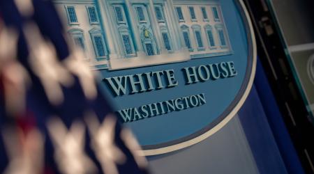 The White House logo is shown in the Press Briefing room of the White House. 