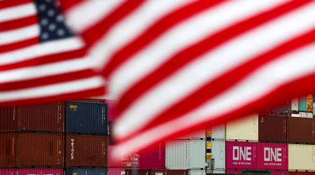 US flags flutter in front of shipping containers at the Port of Long Beach in Long Beach, California. Photo taken on July 11, 2025. 