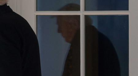 President Trump's reflection is shown on the window of the White House. Photo taken on March 18, 2026. 