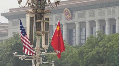 U.S. and Chinese national flags are hoisted at Tiananmen Square in Beijing during U.S. President Donald Trump's visit to Beijing for a summit meeting with Chinese President Xi Jinping on May 14, 2026. 