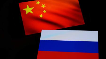 A Chinese and Russian flag are seen in this photo illustration. 