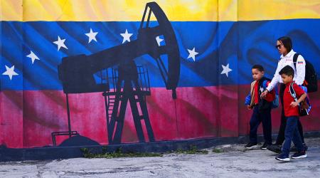 People walk in front of a mural of an oil pump on Venezuela's national flag, near the headquarters of the state-run oil company PDVSA, in Caracas, Venezuela. Picture taken on January 13, 2026. 