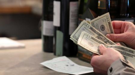 A customer paying for wine at a wine and beer store in Washington, DC. 