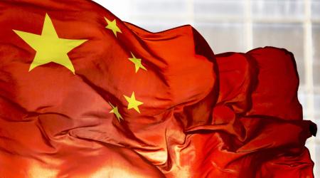 China's national flag flutters at a business district in Beijing, China. 