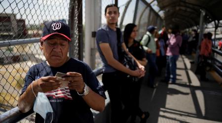 People wait to cross into the U.S. at Paso del Norte international border crossing bridge, as the coronavirus disease (COVID-19) outbreak continues, in Ciudad Juarez, Mexico June 16, 2020. REUTERS/Jose Luis Gonzalez