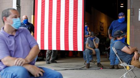 Workers separated for social distancing because of the coronavirus (COVID-19) pandemic listen to Democratic U.S. presidential candidate and former Vice President Joe Biden as he speaks about the U.S. economy during a campaign event at a metal works plant,